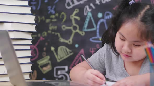 close up Asian girl looking at laptop and book, painting by pencil color