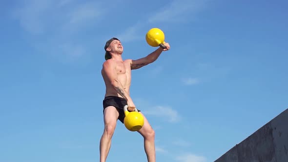 Young Athletic Man Doing Exercise Gorilla Weights Outdoor. Crossfit. Slow Motion alt
