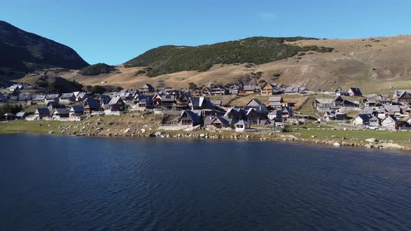 Aerial drone view of a beautiful glacier lake and village on a sunny day