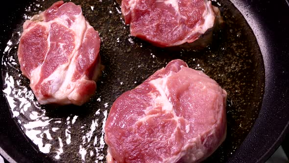 A Piece of Raw Meat Is Fried in Oil