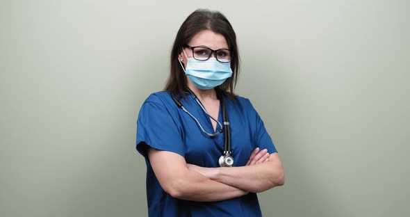 Portrait of Confident Mature Doctor Woman in Medical Protective Mask with Stethoscope alt