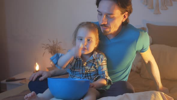 Happy Family Father and Daughter Play on Bed in Evening Watch TV Love Each Other Leisure