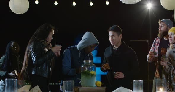 Friends Talking Eating and Drinking on an Urban Rooftop alt