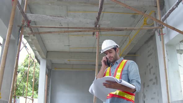 Young caucasian engineer colleagues at site inspector using notebook