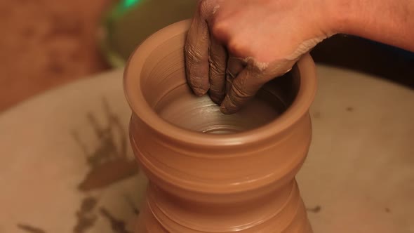 Potter at Work Makes Ceramic Dishes alt