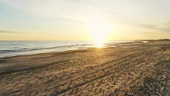 Sunlight Glare From Sky and Waves Gently Crashing Against the Sandy Shores alt