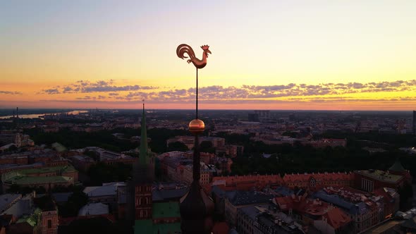 Aerial View of Two Golden Weather Cocks or Roosters of Riga's Old Town During Amazing Scenic Sunrise alt