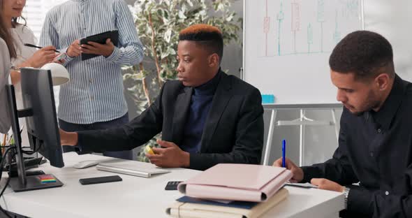 Company Employees Work Together Sit at a Computer Planning Organizing a Project a Man in a Garnish alt