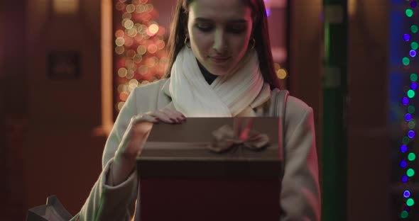 Woman opening a gift box.