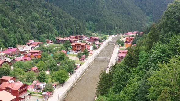 aerial drone view of a mountain village near a river and forest on a sunny summer day in Uzungol Tra alt