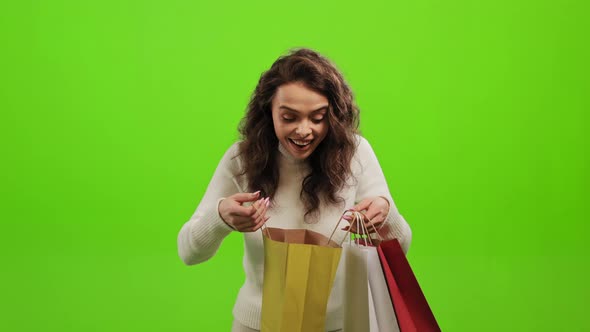 A Woman is Looking Into Shopping Bags alt