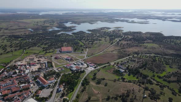 Mourao village and Alqueva lake in background. Aerial drone view alt