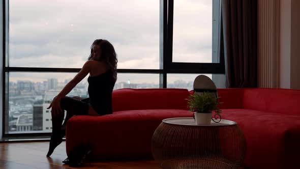 Lonely Sexy Woman is Wearing Erotic Lingerie and Posing on Sofa in Her Apartment alt