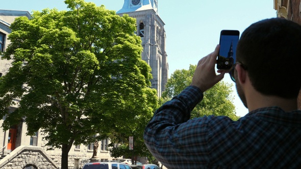 Man Making a Video of Fluff Flying in The Air alt
