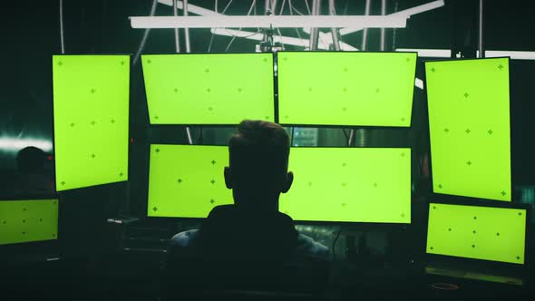 Male Hacker Creating Malware on Computers alt