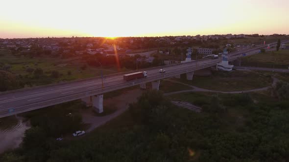 Aerial Shot of a Long Bridge Over the Dnipro at a Splendid Sunset in Summer