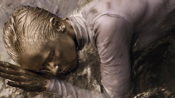 Gold Woman Is Floating in Shallow with Golden Shiny Dye Artistic Shot of Moving Lady alt