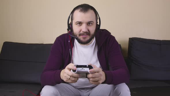 Happy Male Gamer with Headset Play Online Video Game Holding Joystick, Streaming