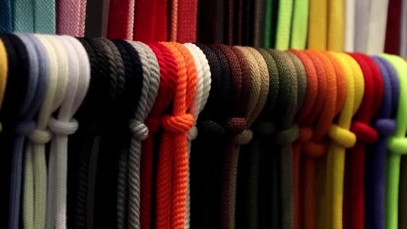 Different Colors of Laces or Rope on the Shelves of a Clothing Factory