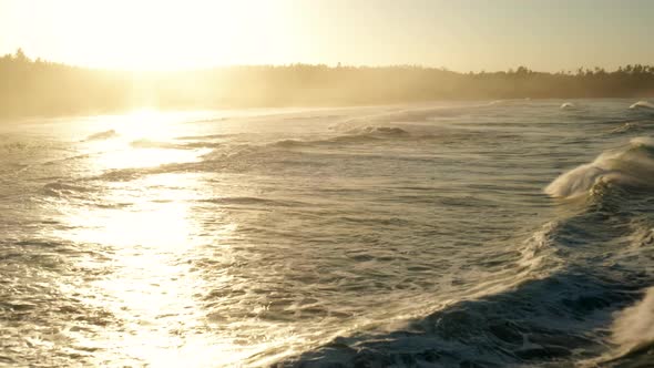 Following large waves at sunrise