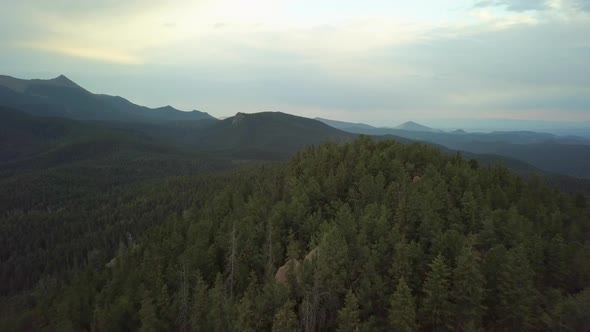 Pull Back Rising Aerial View Revealing a Vast Forest in a Mountainous Colorado Landscape alt