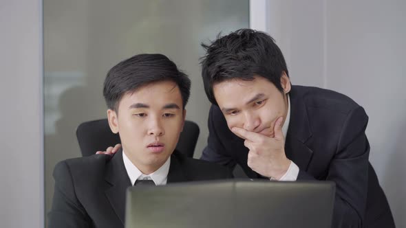 serious stressed two business man using laptop computer to working project alt
