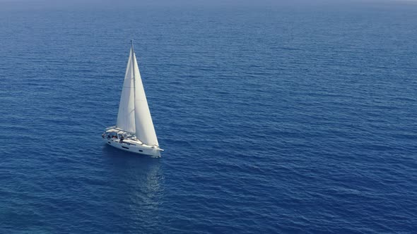 Sail boat sailing in deep blue Aegean sea, aerial drone video alt