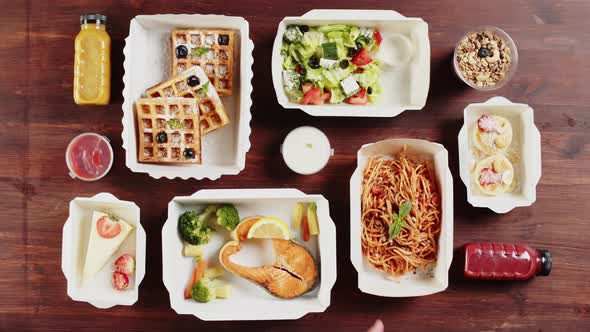 Food Delivery Top View Take Away Meals in Disposable Containers on Wooden Table alt
