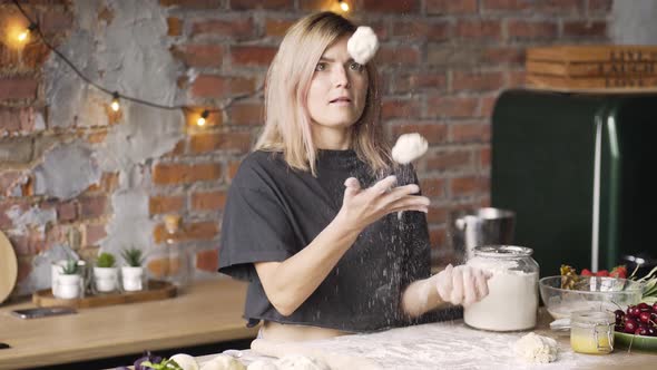 Concentrated Blonde in Tshirt Juggles with Dough