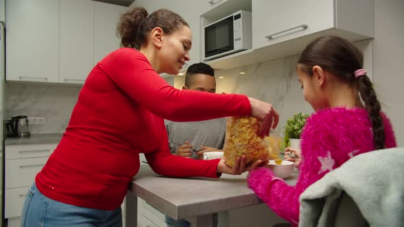 Happy Family with Two Kids Having Breakfast at Home alt