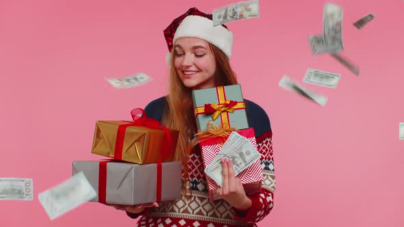 Christmas Girl Holding Gift Boxes Concept of Spending Money Shopping Online Cash Dollars Falling alt