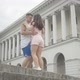 Young Caucasian Couple Dancing on City Square at the Background of Beautiful Building, Cheerful Man - VideoHive Item for Sale