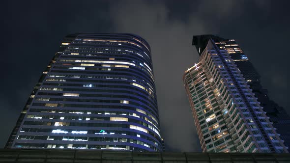 Time Lapse, Top of Skyscrapers at Clouds Background in The Night Time