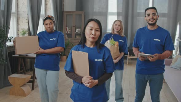 Multi-Ethnic Team of Volunteers in Blue T-Shirts alt