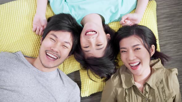 Happy Asian family mom dad and boy male kid child laying laugh smile on the floor