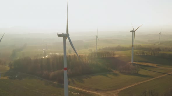 Panoramic View of a Farm with Wind Turbine at Sunset alt