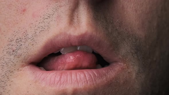 Man Erotically Licks His Lips With His Tongue CloseUp alt