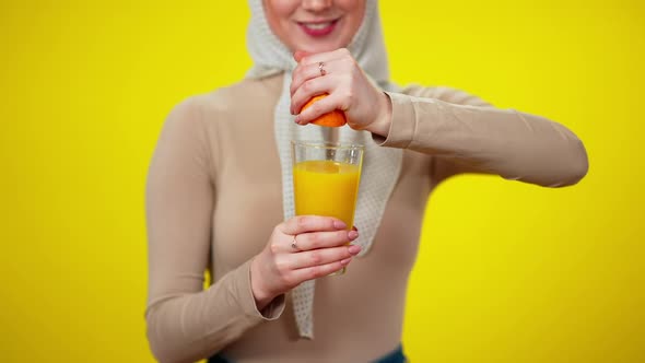 Unrecognizable Slim Woman Squeezing Orange in Glass in Slow Motion alt