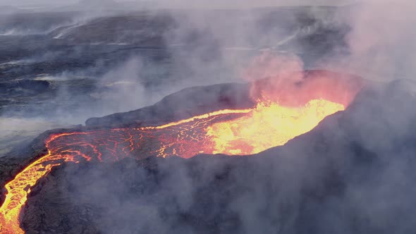 Fiery Lava Flowing From The Crater Of An Active Volcano During Eruption. close up, aerial alt