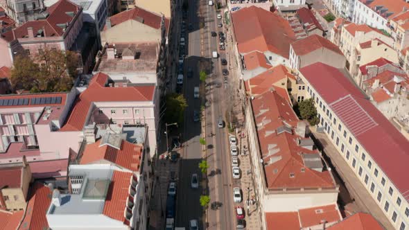 Aerial Dolly in Reveal of Multi Lane Road Traffic Through Lisbon City Center Surrounded By alt