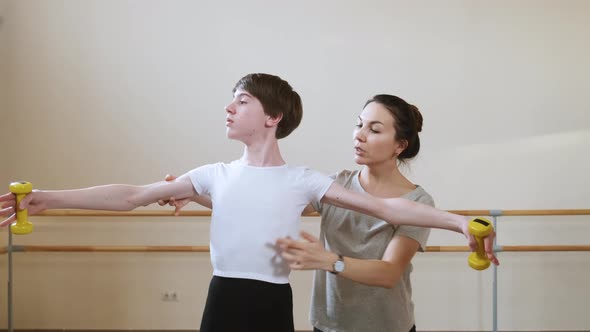 Ballet Gymnastics Class Teacher Choreographer Helps Student to Improve Exercise