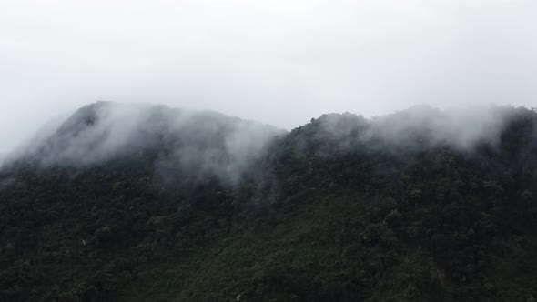 Flying over a foggy mountain in Hainan. Right to left, Stock Footage