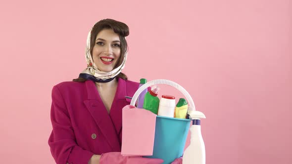 A Stylish Woman Holds a Bucket of Cleaning Tools in the House