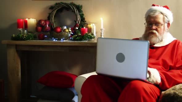 Santa claus using laptop alt