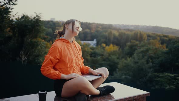 The Young Freelancer Finishes Her Work Tired Closes Her Laptop Twists Her Neck a Little and Then alt