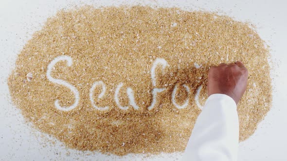Hand Writes On Beach Sand Sea Food alt