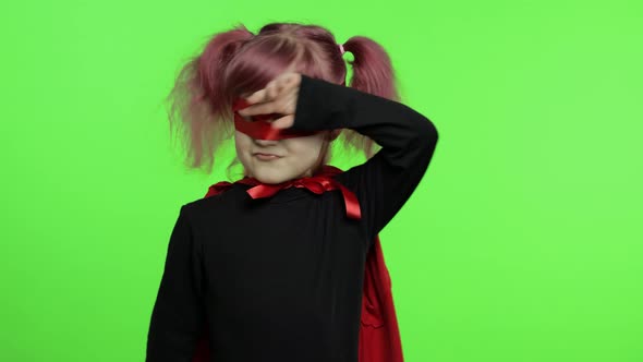 Funny Child Girl in Costume and Mask Plays Super Hero. National Superhero Day alt