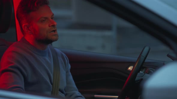 Man Sits in a Car and is Angry That He Was Stopped By the Police for Violating Traffic Rules alt