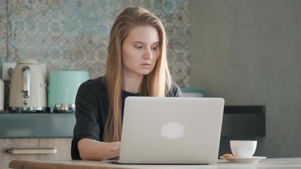 Focused Girl Using Computer for Study Online at Home. Self Isolation Concept.