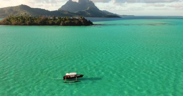 Boat Crossing the Ocean Revealing the View of Bora Bora alt